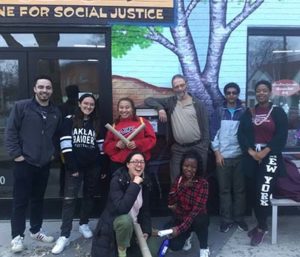 Ricardo Levins Morales with a group of students after a workshop