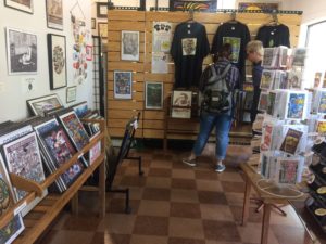Inside of shop with posters, notecards and tee shirts for sale
